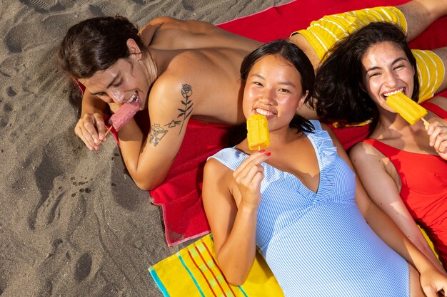 People eating ice cream on beach top view