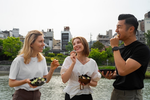 Free photo people eating seaweed snacks