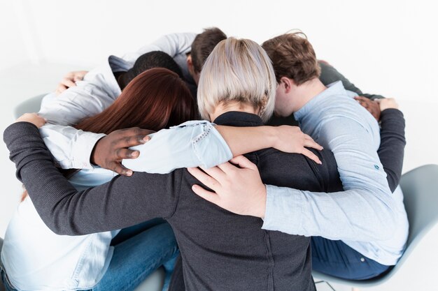 People embracing and gathering in a circle