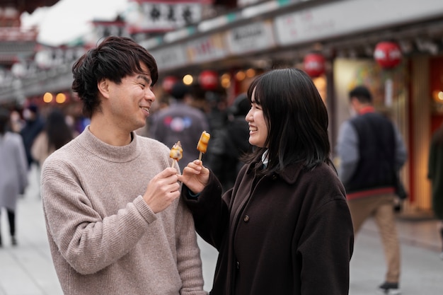 日本の屋台の食べ物を楽しむ人々