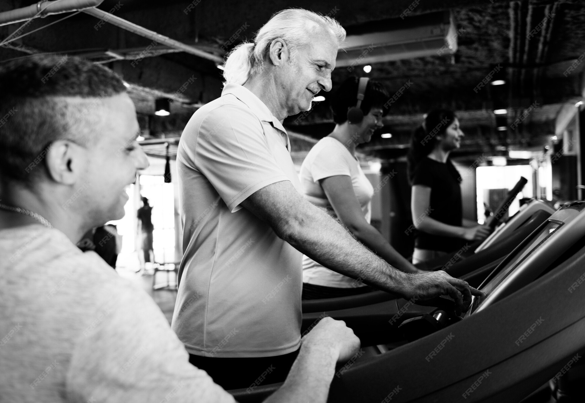  A group of diverse people exercising on treadmills in a gym to prevent stroke.