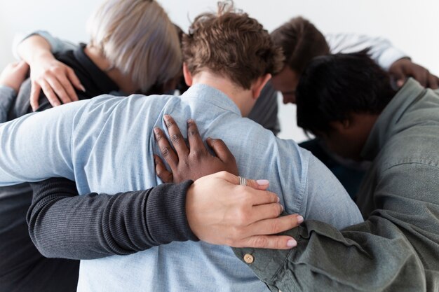 People forming a circle and embracing