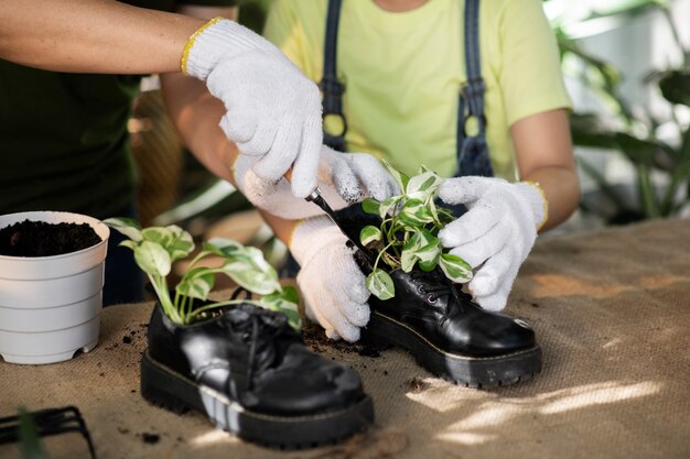 People gardening with old shoes high angle