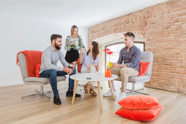 People gathering at table with coffee