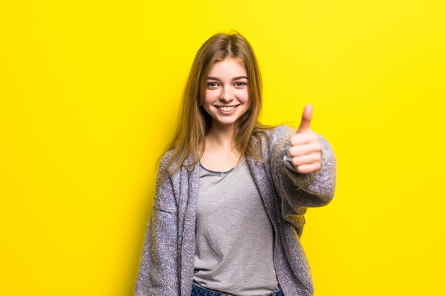People, gesture, style and fashion concept - happy young woman or teen girl in casual clothes showing thumbs up