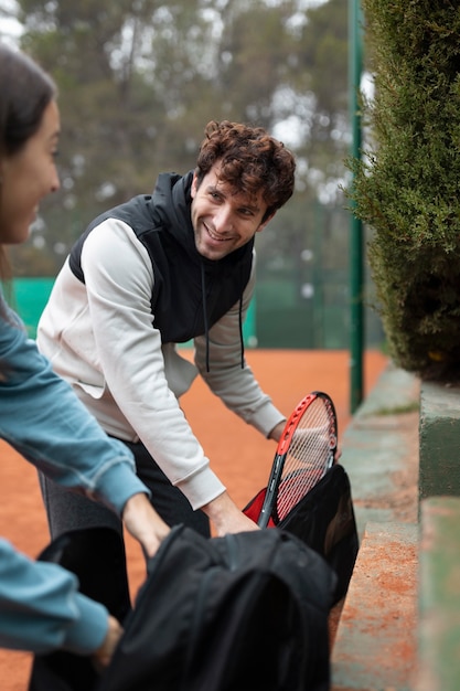 People getting ready for tennis game in winter time