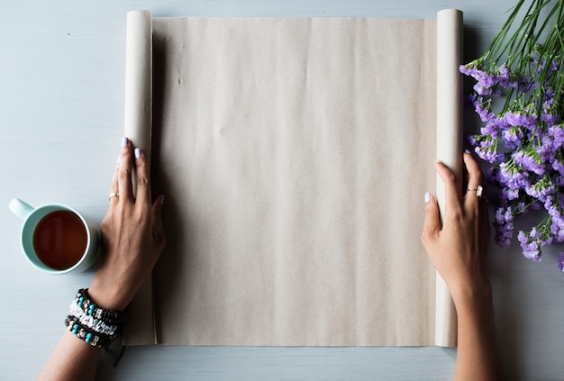 Free photo people hands showing blank empty design space paper roll