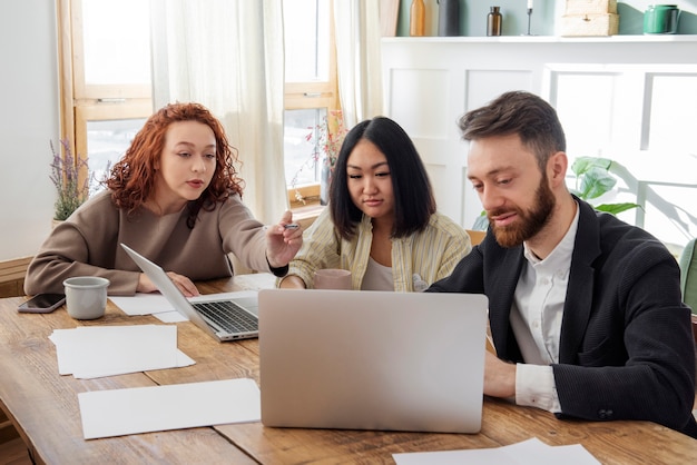 People having a debate while looking over computer