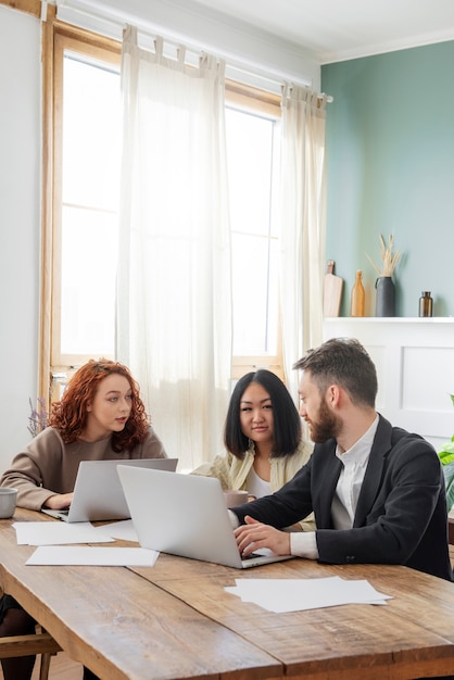 People having a debate while looking over computer