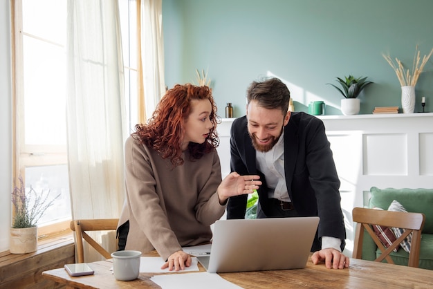 People having a debate while looking over computer