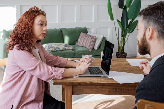 People having a debate while looking over computer