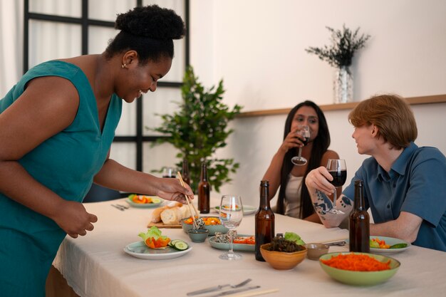 People having food and drinks at a dinner party