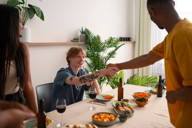 People having food and drinks at a dinner party