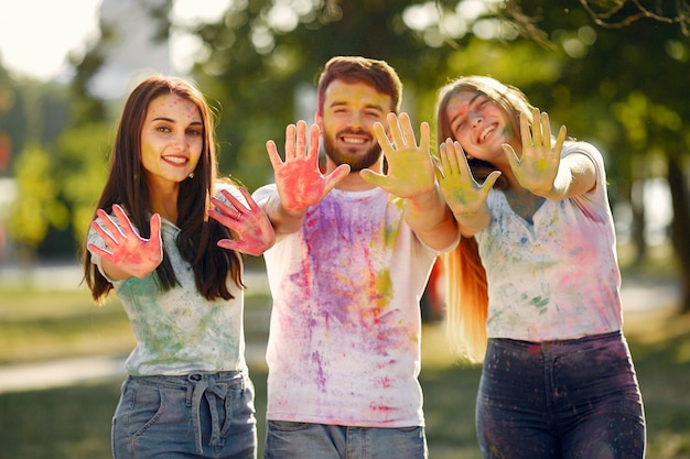 People having fun in a park with holi paints