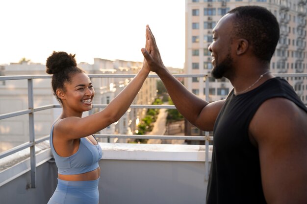 People high-fiving each other while training outdoors