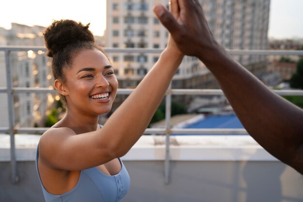 People high-fiving each other while training outdoors