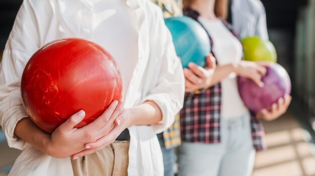 People holding bowling balls