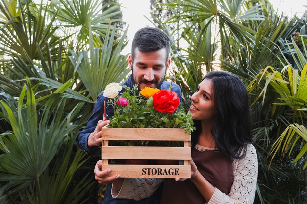 People holding box with flowers