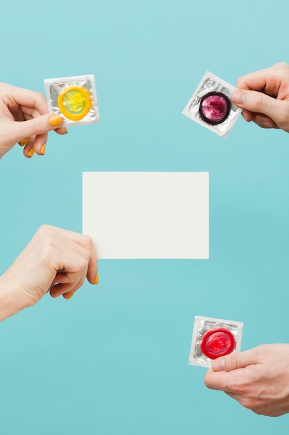 People holding different condoms and an empty card