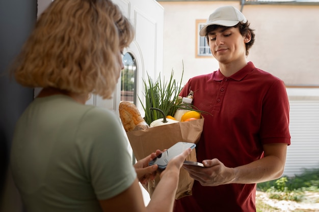 Free photo people holding groceries bag medium shot