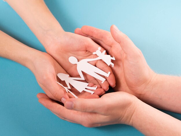 people holding in hands cute paper family