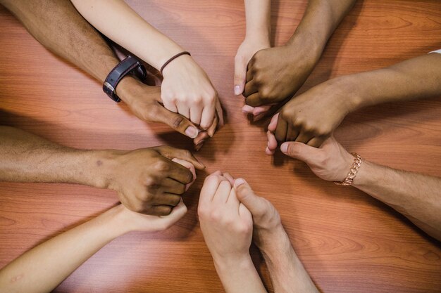 People holding hands on table