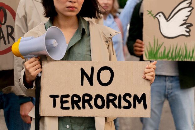 People holding no terrorism placard at protest