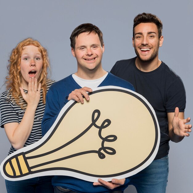 People holding a paper light bulb