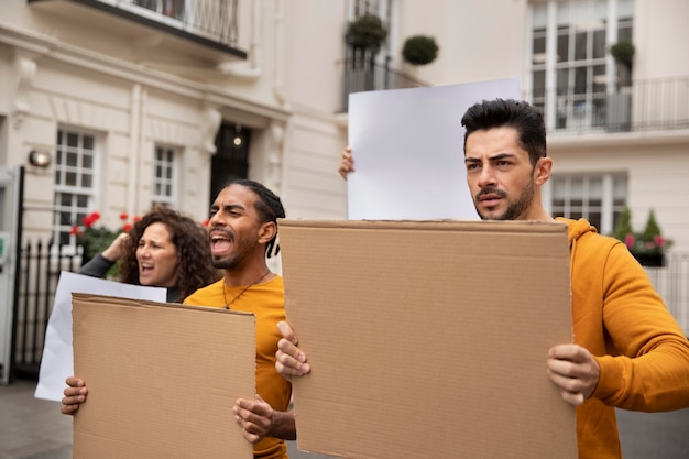 Free photo people holding placards medium shot