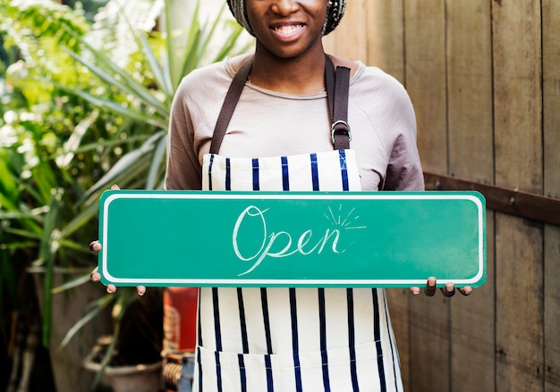 Free photo people holding shop open sign