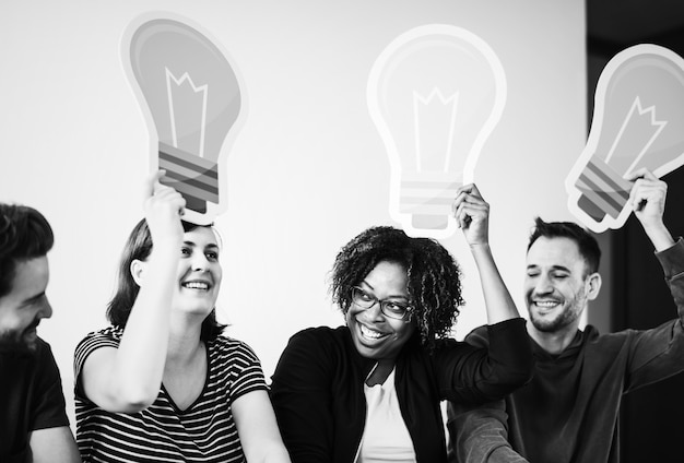 People holding up light bulb icons