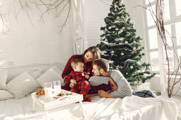 People at home. Family in a pajamas. Milk and croissants on a tray.