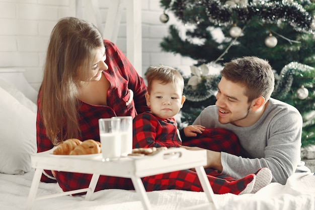 People at home. Family in a pajamas. Milk and croissants on a tray.