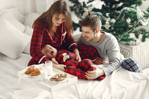 People at home. Family in a pajamas. Milk and croissants on a tray.