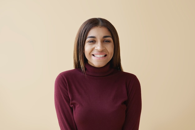 People, joy and happiness concept. Horizontal happy cheerful fashionable young brunette African American woman grinning broadly, feeling happy after good shopping in the sale