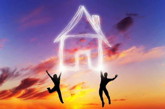 People jumping at sunset with a house