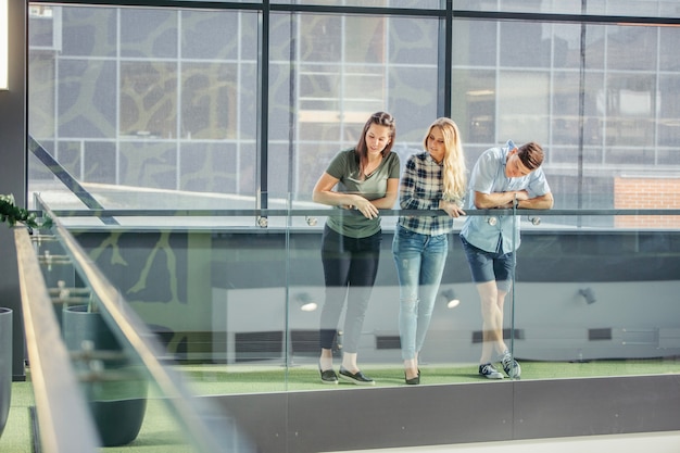 People leaning on handrail