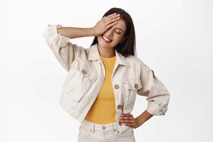 Free Photo people lifestyle. happy adult woman with carefree smiling face expression, con one eye and standing in casual relaxed pose, enjoy summer on white.