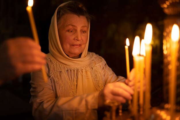 People lighting candles in church in celebration of greek easter