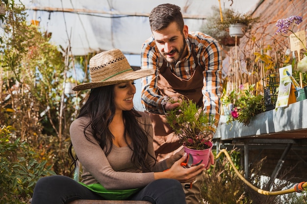 People looking at potted plant