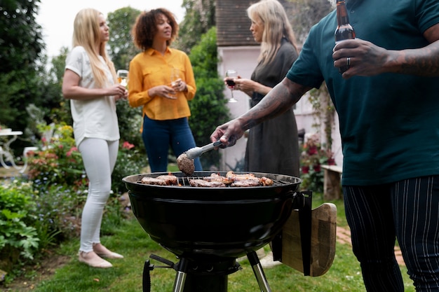 People making barbecue together side view
