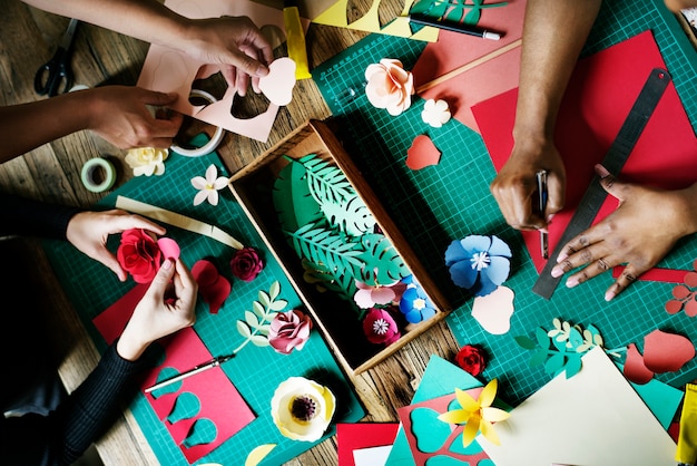 Free photo people making paper flowers craft art work handicraft