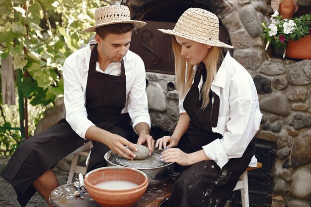 People making vases with clay