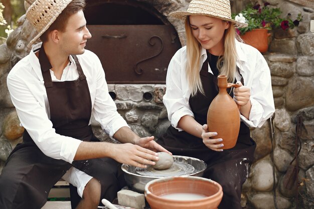 People making vases with clay