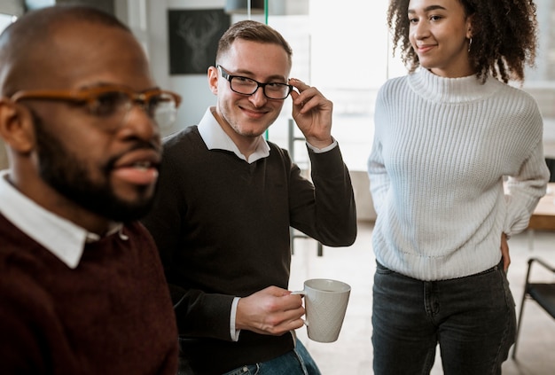 People in a meeting discussing over coffee