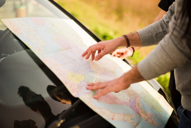 People navigating with map on a road trip