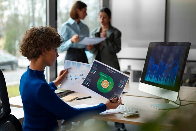 people in the office analyzing and checking finance graphs