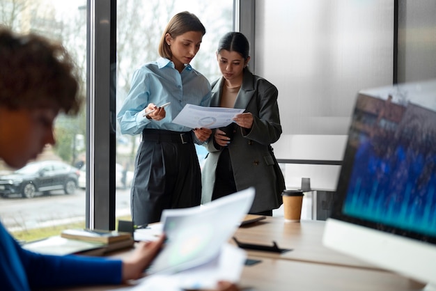 people in the office analyzing and checking finance graphs