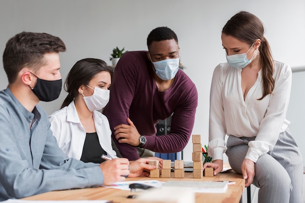 People in the office during pandemic having a meeting together