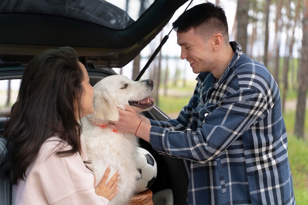 People petting dog medium shot